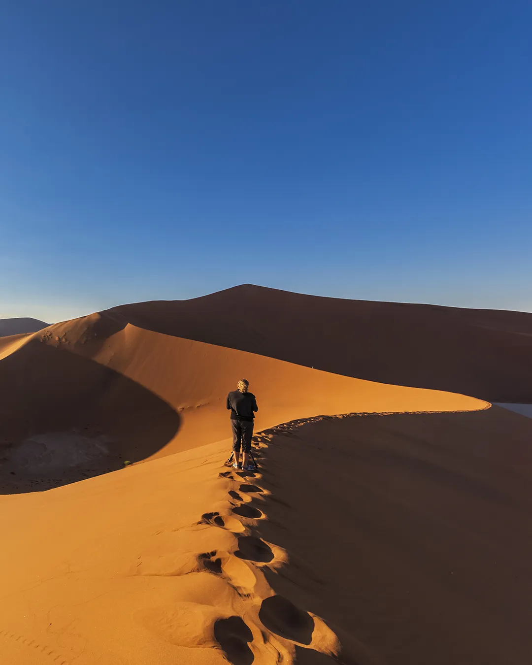 Woman walking on a dune in Namibia
